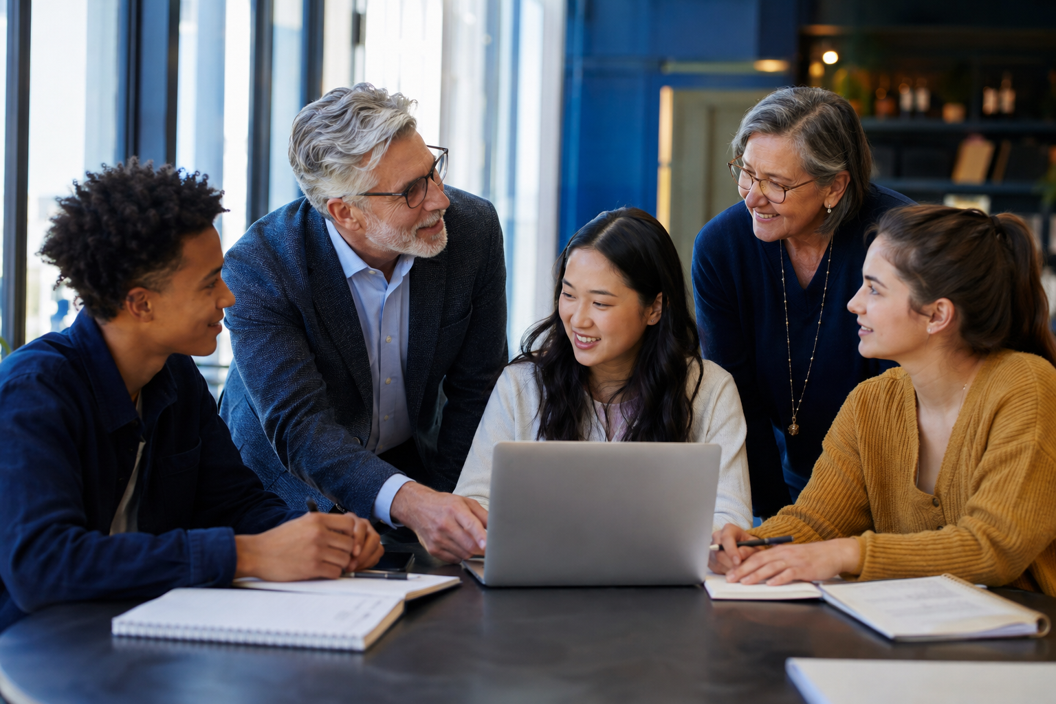 Experienced adults mentoring young people in a collaborative learning space